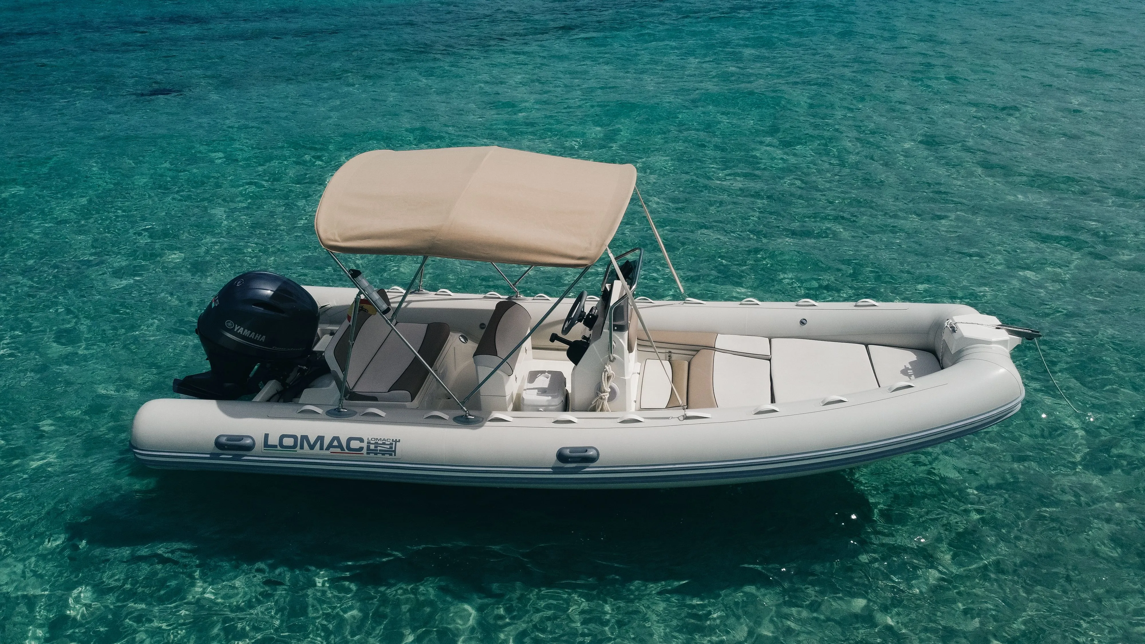 Explore Sant Antoni de Portmany on a 6m Lomac 600 Motor Boat Rental