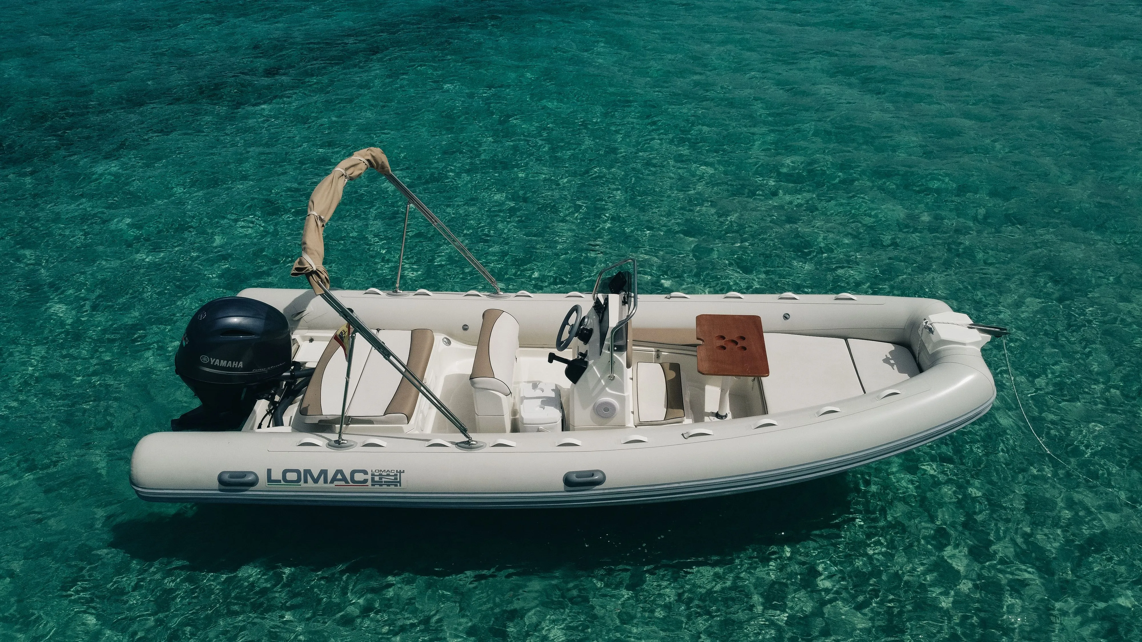 Explore Sant Antoni de Portmany on a 6m Lomac 600 Motor Boat Rental