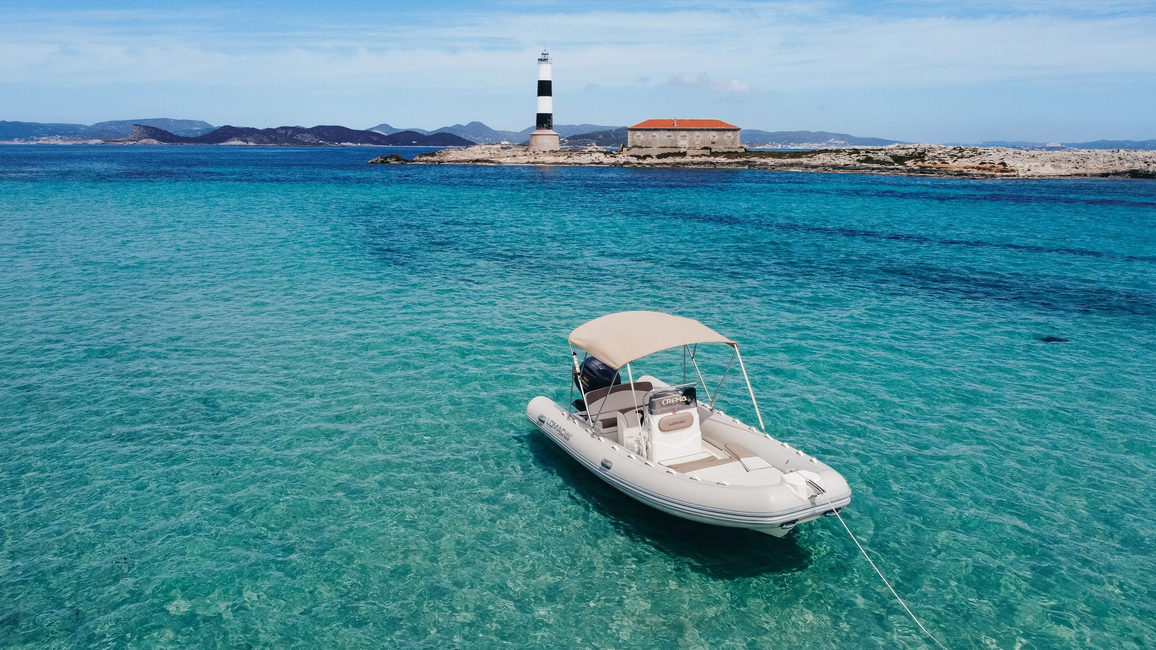 Explore Sant Antoni de Portmany on a 6m Lomac 600 Motor Boat Rental
